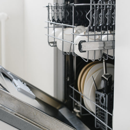 dishwasher-close-up-with-door-opened-and-dishes-inside-fort-collins-co
