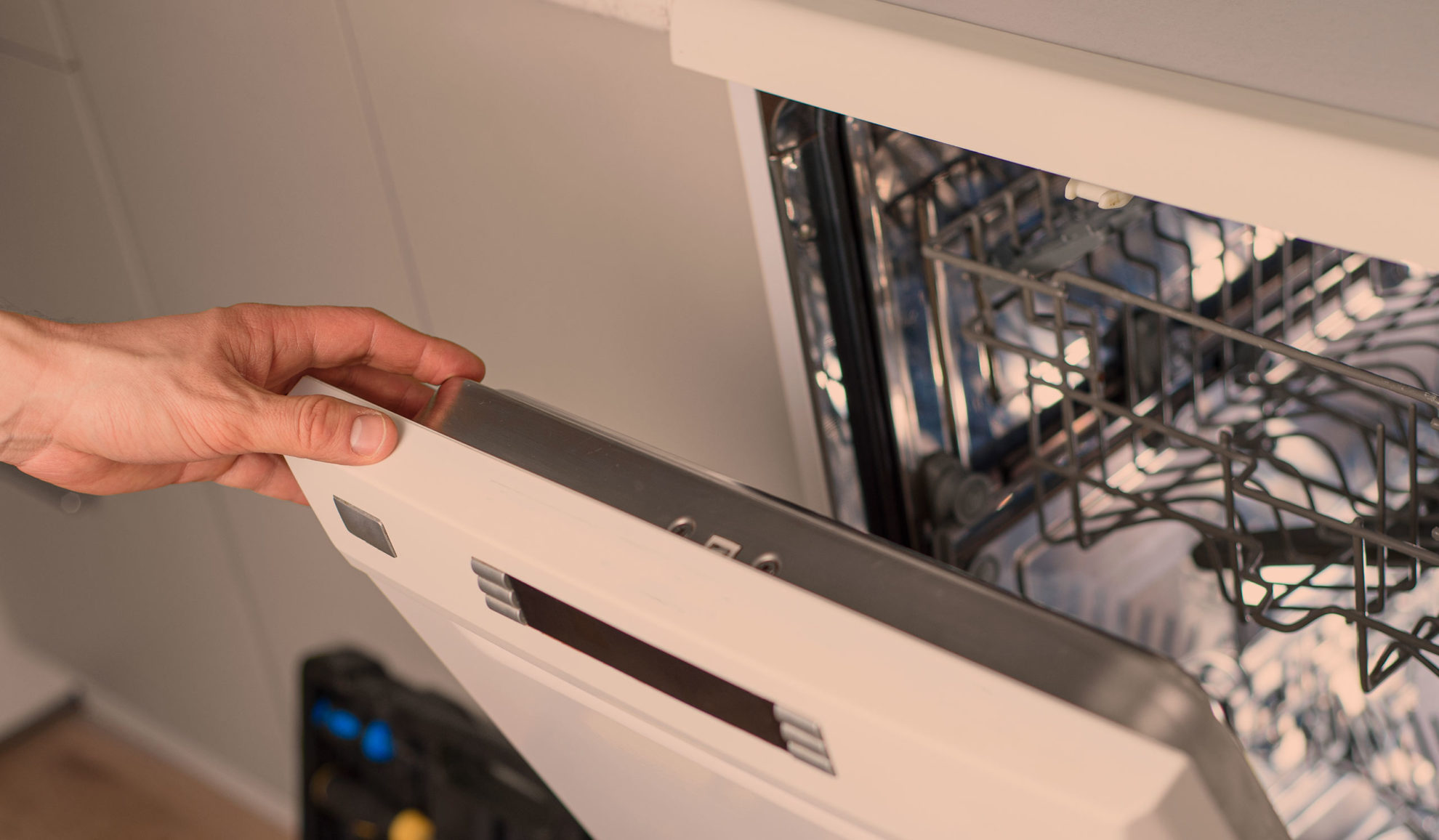technician-hand-close-up-holding-dishwasher-door-opened-after-repairing-fort-collins-co