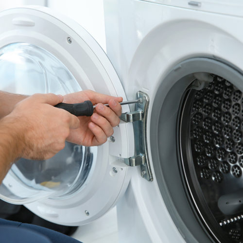 technician-hands-close-up-with-screwdriver-repairing-washer-machine-fort-collins-co