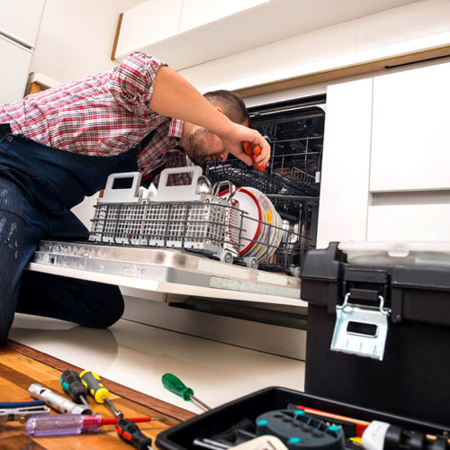 technician-repairing-kitchen-dishwasher-with-tools-on-the-floor-fort-collins-co