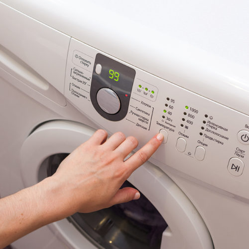woman-hand-close-up-pressing-dryer-machine-buttons-fort-collins-co